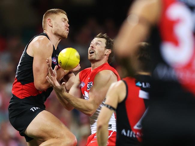 SYDNEY, AUSTRALIA - MARCH 23: Harry Cunningham of the Swans is challenged by Peter Wright of the Bombers during the round two AFL match between Sydney Swans and Essendon Bombers at SCG, on March 23, 2024, in Sydney, Australia. (Photo by Mark Metcalfe/AFL Photos/via Getty Images )