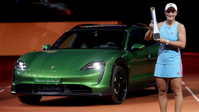 Ash Barty with the trophy and a Porsche Taycan Turbo S Cross Turismo after winning the final match against Aryna Sabalenka. Picture: Getty Images