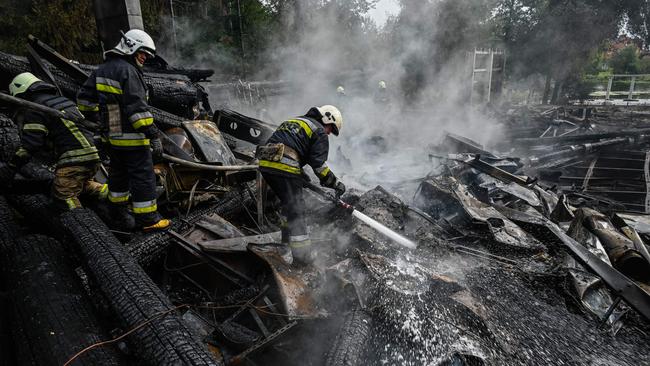 Firefighters douse the rubble of a restaurant complex destroyed by a missile strike in Kharkiv on Sunday. Picture: AFP