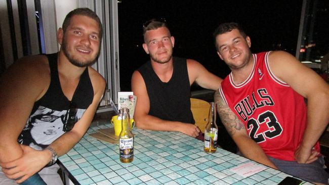 At Helm Bar (from left) are Sam Morton and James Barker, from England, with Dale Vivian, enjoying a sunset drink