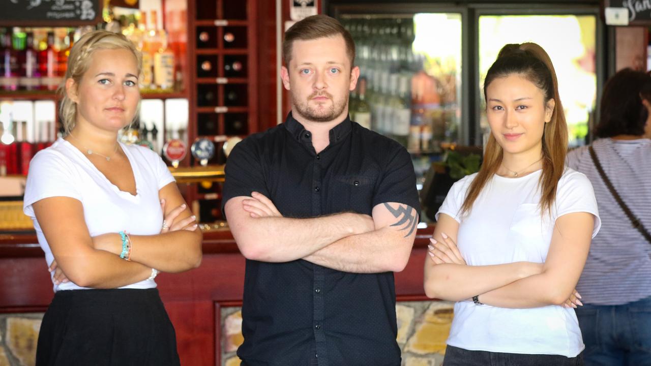 Deck Bar hospitality workers Sophie Hampton, Derek Duffy and Evelyn Tran are fed up with a lack of certainty for their industry. Picture: Glenn Campbell