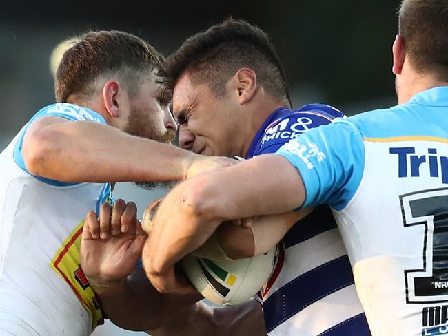 John Olive of the Bulldogs is tackled by the Titans defence  during the Round 15 NRL match between the Canterbury-Bankstown Bulldogs and the Gold Coast Titans at Belmore Sports Ground in Sydney, Saturday, June 16, 2018. (AAP Image/Brendon Thorne) NO ARCHIVING, EDITORIAL USE ONLY