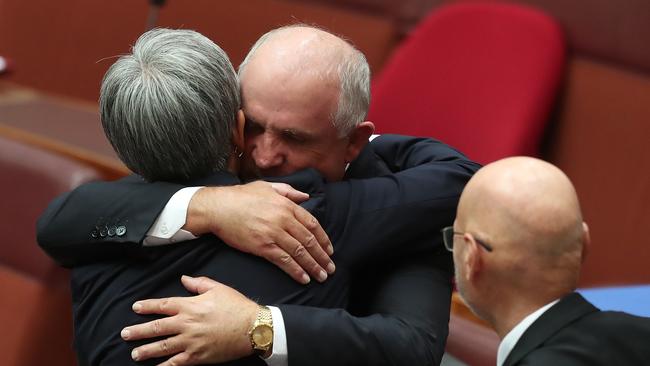 Senator Penny Wong hugs Senator John Williams after his Valedictory speech in the Senate Chamber at Parliament House in Canberra. Picture: Kym Smith