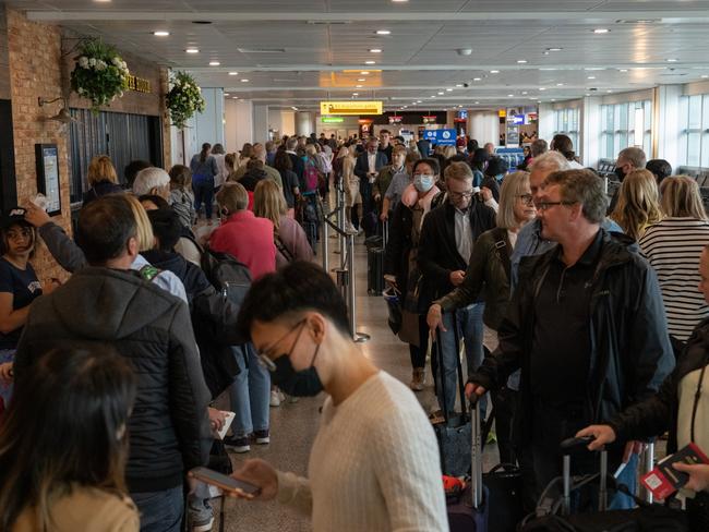 Travellers wait in a long queue to pass through the security check at Heathrow. Picture: Carl Court/Getty Images