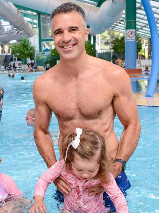 Premier Peter Malinauskas, pictured with his daughter Eliza, made a splash with his election promise at the Adelaide Aquatic Centre in North Adelaide. Picture: Brenton Edwards