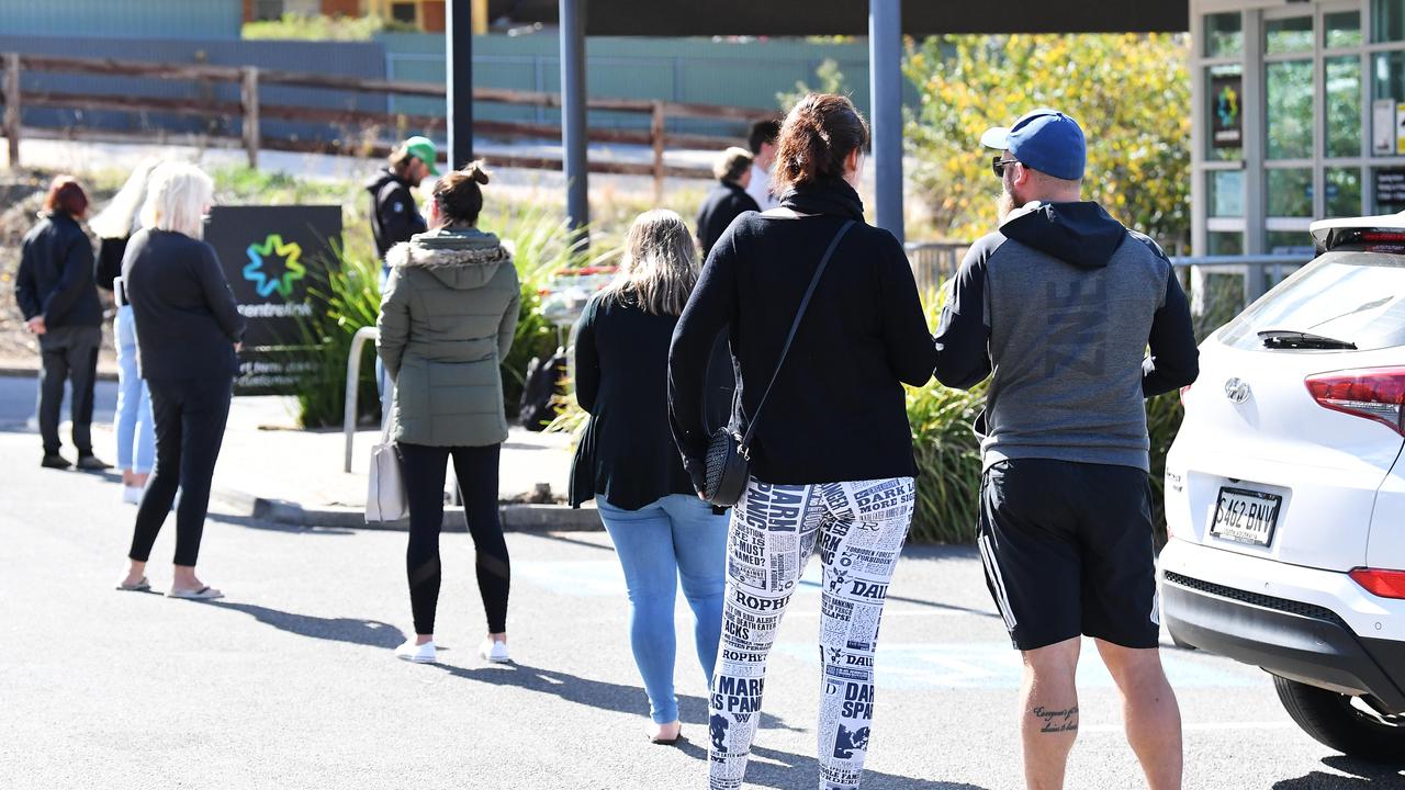 People line up in the car park at the Mount Barker Centrelink office in South Australia on Wednesday. Picture: Mark Brake/AAP