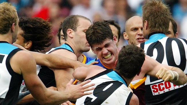 FIERY CLASH: Lion Jonathan Brown lines up Port’s Josh Carr as the teams come to blows in the 2004 AFL grand final.