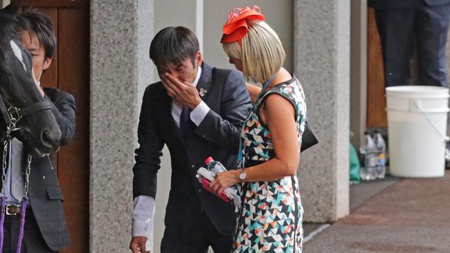 Skikato Kayoshi, Admire Ratki’s strapper, is reduced to tears after the horse’s death.