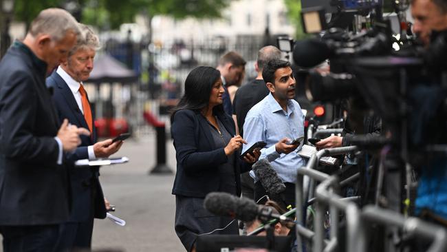 Journalists gather outside 10 Downing Street in London. Picture: AFP.