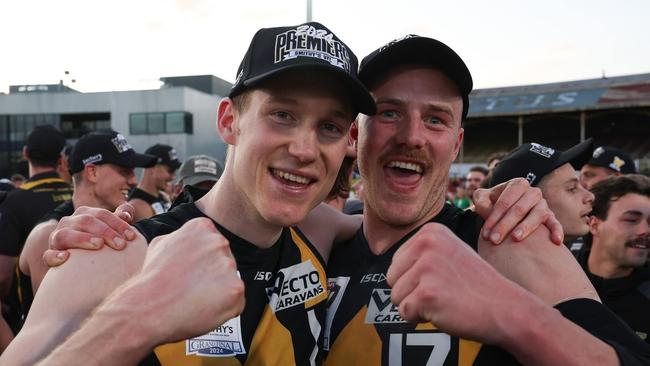 Aidan Johnson (right) whoops it up after Werribee's premiership win in the VFL this year.