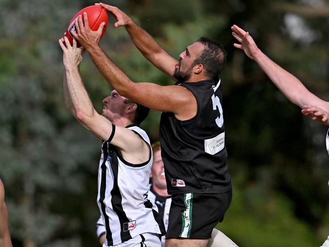 Eastern: Donvale’s James Rausa plucks the ball from the Scoresby defender. Picture: Andy Brownbill