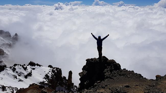 Climber Steve Plain on the crater rim at the top of Mount Kilimanjaro.