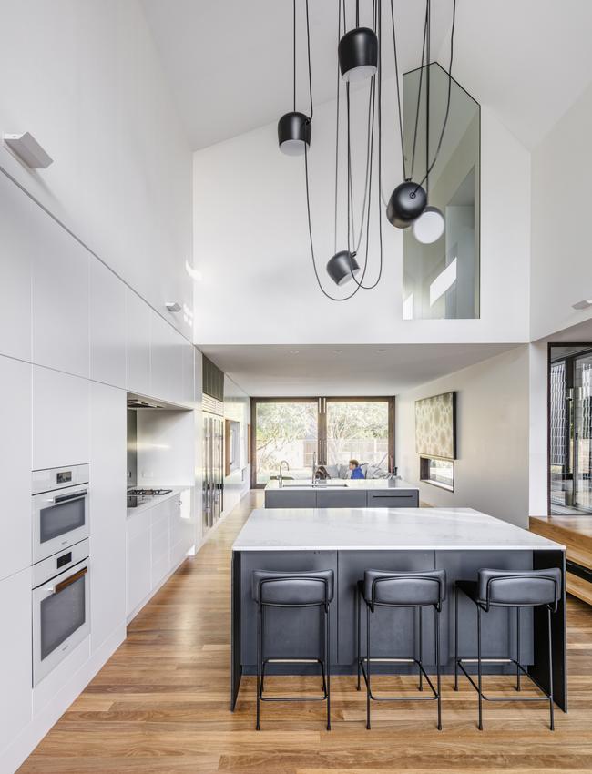 The kitchen feels much larger than it is thanks to a generous void and careful management of natural light.