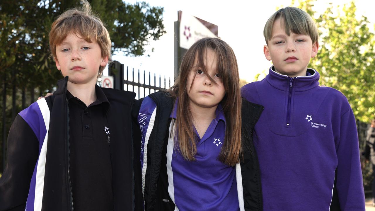 Shawn, 9, Olivia, 9 and Ethan, 11, outside Northern Bay College’s Hendy St campus that was damaged by a suspicious fire this week. Picture: Alison Wynd.