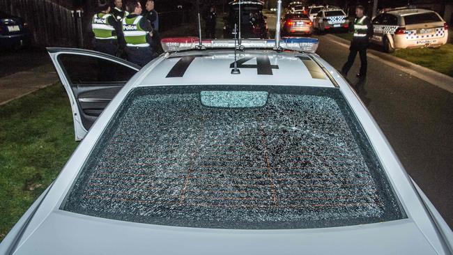 A police car damaged during a riot in Taylors Hill. Picture: Jason Edwards