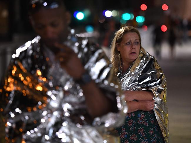 Members of the public, wrapped in emergency blankets leave the scene of a terror attack on London Bridge. Picture: AFP