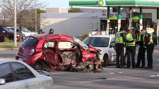 Police at the scene of the fatal crash, which involved a stolen car running a red light on Main North Rd at Parafield. Picture: AAP/Dean Martin