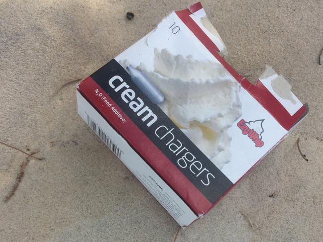 Canisters found on the sand dunes just metres away from a hotel where a schoolie plunged to his death from a balcony after allegedly inhaling nitrous oxide. Picture: Nic McElroy