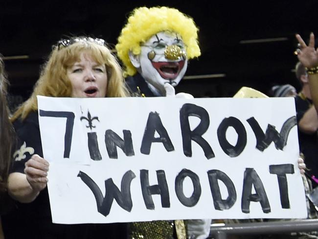 FILE - In this Sunday, Nov. 4, 2018, file photo, New Orleans Saints fans react after an NFL football game against the Los Angeles Rams in New Orleans. Here comes Who Dey vs. Who Dat. Say what? The Who Dat folks from New Orleans go head-on with the Who Dey fans in Cincinnati on Sunday. And don't ask which group first came up with its catchy phrase and odd rendering of the English language. (AP Photo/Bill Feig, File)