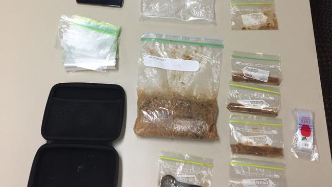 Drugs and items uncovered during a police search in Airlie Beach on Thursday. Police allege more than 1kg of MDMA was uncovered.