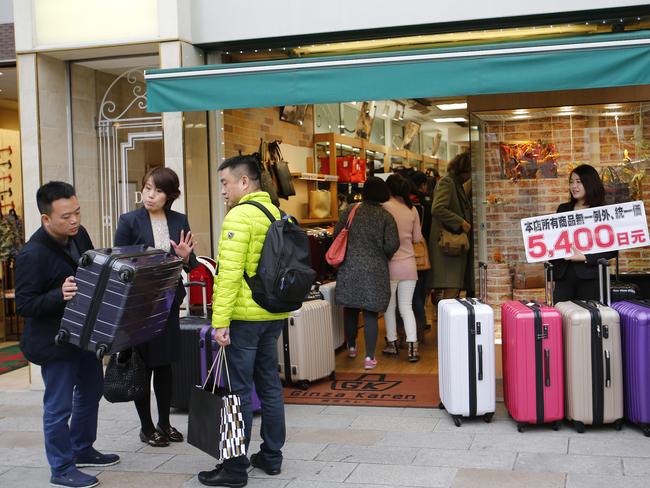 Chinese shoppers haggle for a bargain in Tokyo. AP Photo/Shizuo Kambayashi.