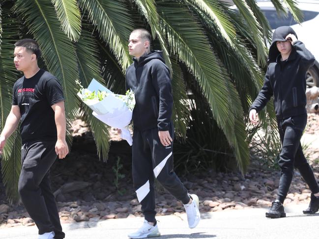 Friends lay flowers in tribute. Picture: David Crosling