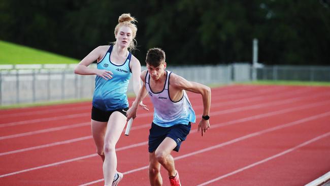 Aspire running group in 2020 – Emma Henley hands Luke Melellan the baton for the final lap of the race. PICTURE: BRENDAN RADKE