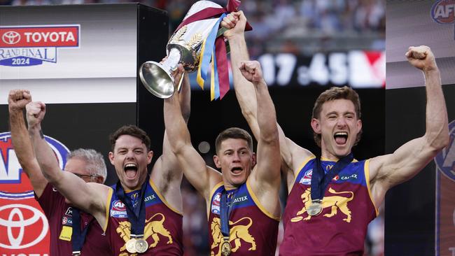 MELBOURNE, AUSTRALIA - SEPTEMBER 28: Chris Fagan, Senior Coach of the Lions, Lachie Neale, Dayne Zorko and Harris Andrews of the Lions celebrate with the 2024 AFL Premiership Cup after winning the AFL Grand Final match between Sydney Swans and Brisbane Lions at Melbourne Cricket Ground, on September 28, 2024, in Melbourne, Australia. (Photo by Daniel Pockett/AFL Photos/Getty Images)