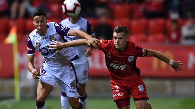 Adelaide United’s Scott Galloway battles for the ball with Perth Glory’s Chris Ikonomidis during the Reds’ A-League loss. Picture: Mark Brake/Getty Images