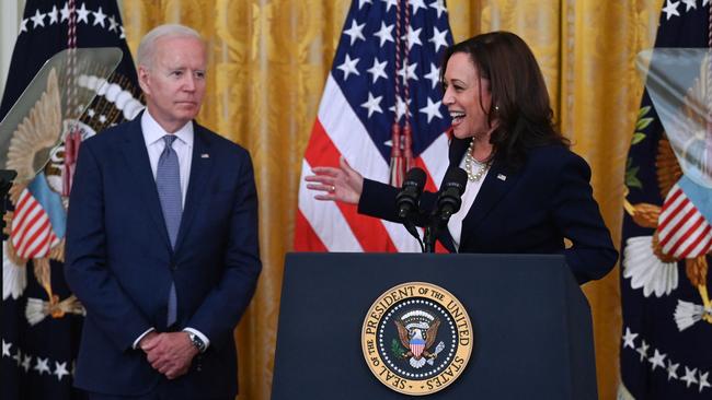 Vice President Kamala Harris speaks as President Joe Biden looks on during a press conference at the White House.