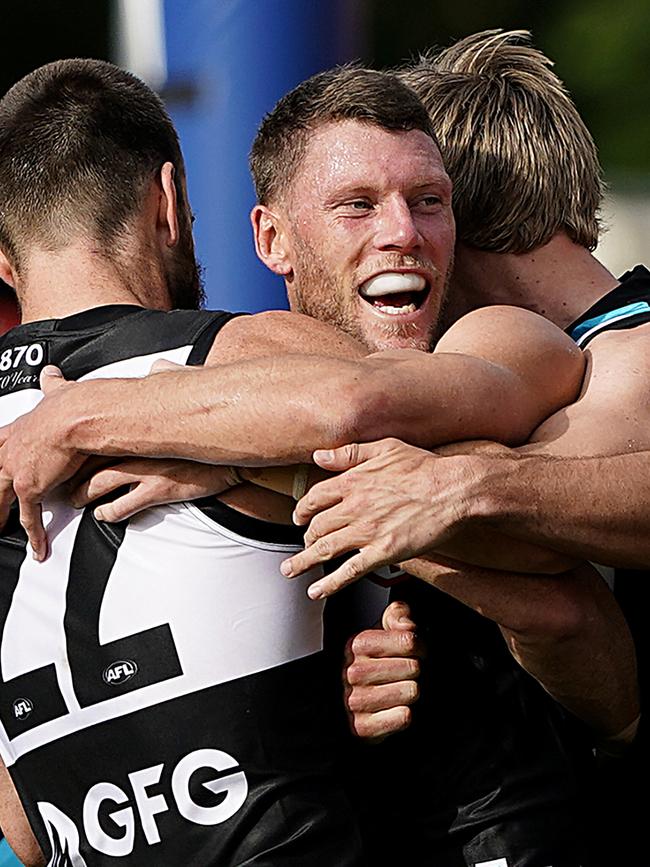 Brad Ebert is mobbed by teammates after kicking a goal in his 250th game.