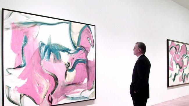 A curator at New York’s Museum of Modern Art looks at paintings by Willem de Kooning in 1997 when the artist died. The painting on the left is Untitled Xll from 1982. Picture: AP