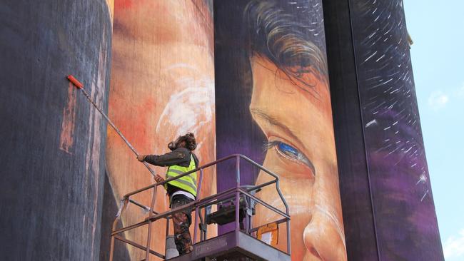 The Sheep Hills silo art takes shape high above the paddocks.