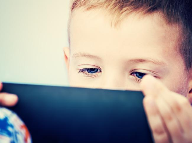 Little boy child kid playing games on smartphone mobile phone. Child use Digital Tablet