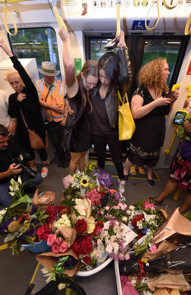 Mourners ride the 86 tram filled with floral tributes to Aiia Maasarwe. Picture: Tony Gough