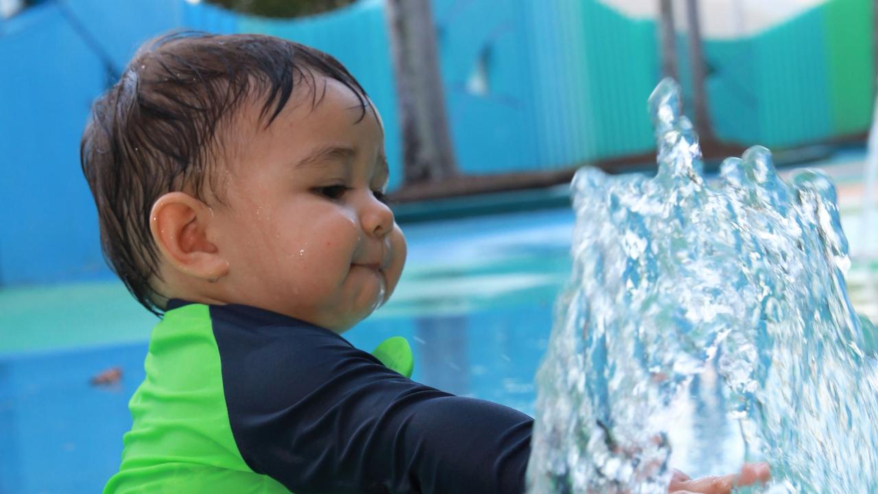 Freddy Burdell, 13 months, from Chillagoe enjoys a splash at Muddy's Playground on the Cairns Esplanade. Picture: Peter Carruthers