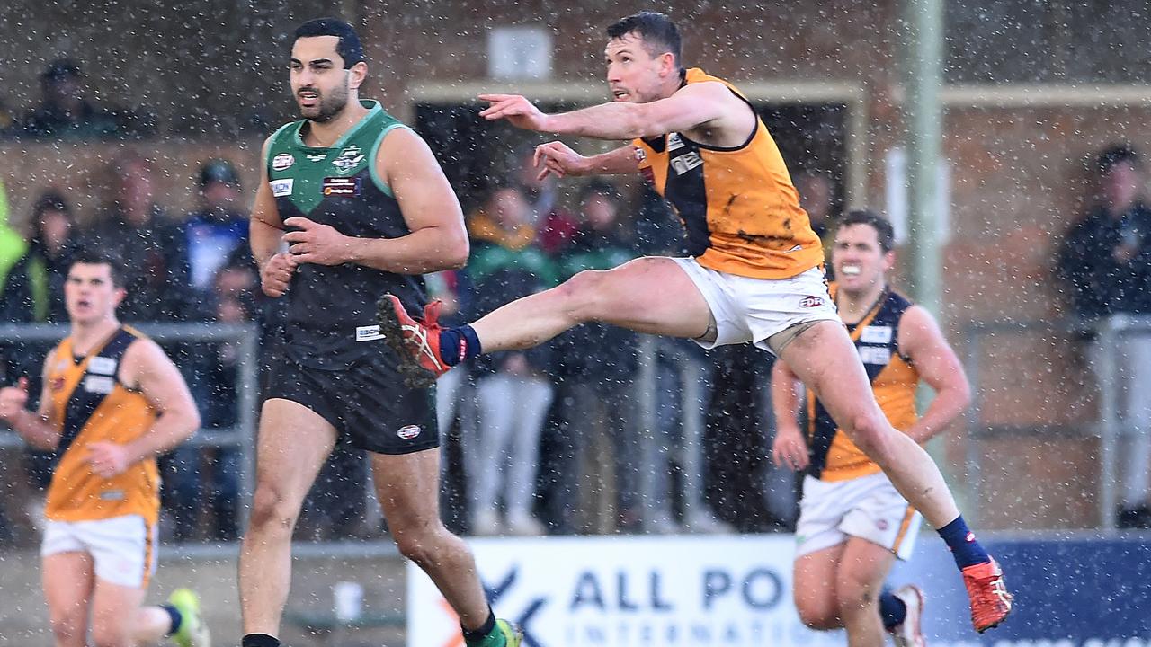 Essendon District: Strathmore’s Mitch Purcell kicks forward against Greenvale. Picture: Steve Tanner