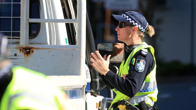 Police inform drivers of a pass change that will be required as the state opens its borders next week. Picture: Adam Head