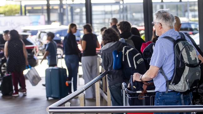 Passengers at the Sydney International Airport queuing at the taxi rank could face being charged $40 more on a ride into the city. Photo Jeremy Piper