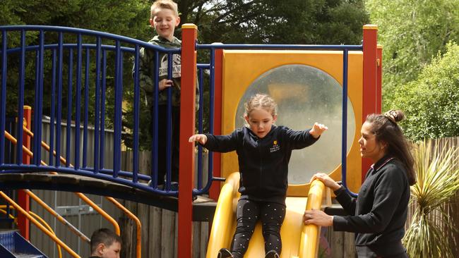 Ashleigh heads down the slide as Ms Murphy looks on. Picture: Stuart Milligan