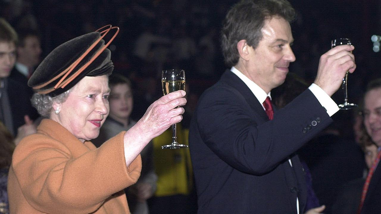 Queen Elizabeth raises a glass of champagne alongside former British Prime Minister Tony Blair during New Year’s celebrations in 1999. Picture: Tim Graham Picture Library/Getty Images