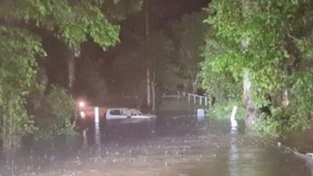 A motorist in the Sunshine Coast hinterland is stranded in floodwaters. Picture: 7 News