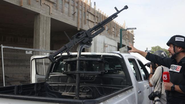 Journalists take pictures of a pickup truck mounted with machine gun in the southern city of Sderot on October 7, 2023, after the Palestinian militant group Hamas launched a large-scale surprise attack on Israel. Picture: AFP