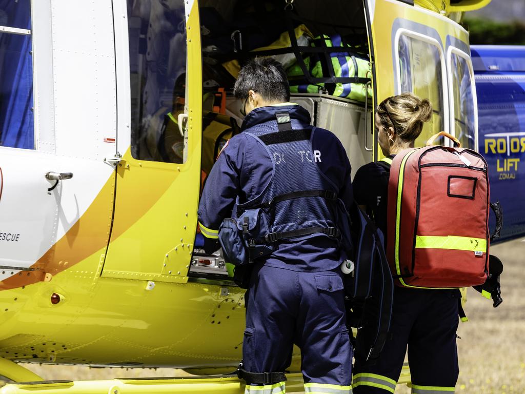 Emergency crew leaving the Rotorlift air base at Hobart Airport. Picture: Linda Higginson