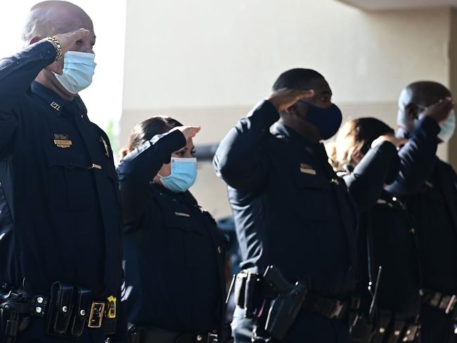 The police salute as the casket with George Floyd arrives the Fountain of Praise church. Picture: AFP