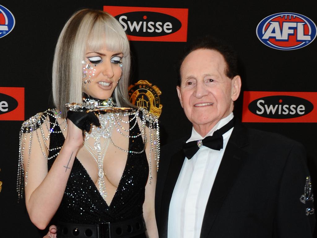 Gabi Grecko pretends to stab Geoffrey Edelsten at the Brownlow Medal awards in 2014.