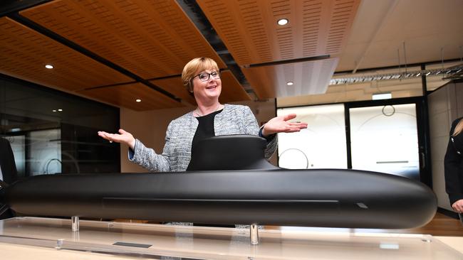 Federal Defence Minister Linda Reynolds poses for a photo next to a model of the Barracuda-class submarine during a visit to Naval Group in Adelaide. Picture: AAP