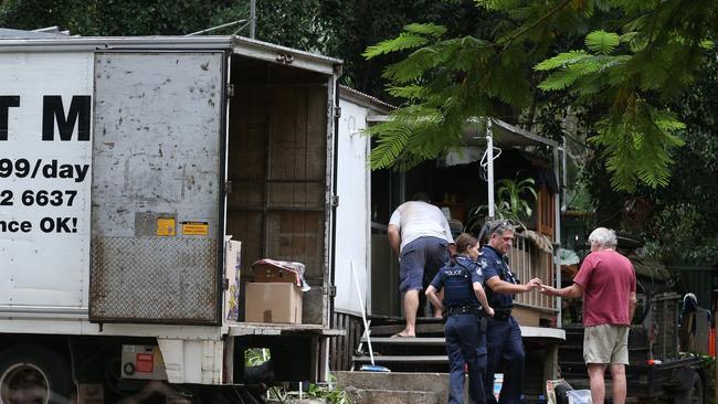 A Police officer hands the keys to owner Rob of the cabin where Shelley Williams was living. She was evicted from the Mudgeeraba Holiday Village yesterday. Photo: Regi Varghese