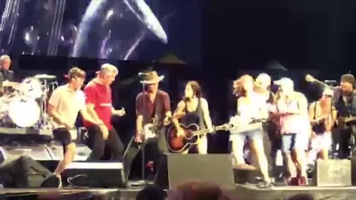 Bruce Springsteen is handed an Akubra hat by a fan at his Hunter Valley gig