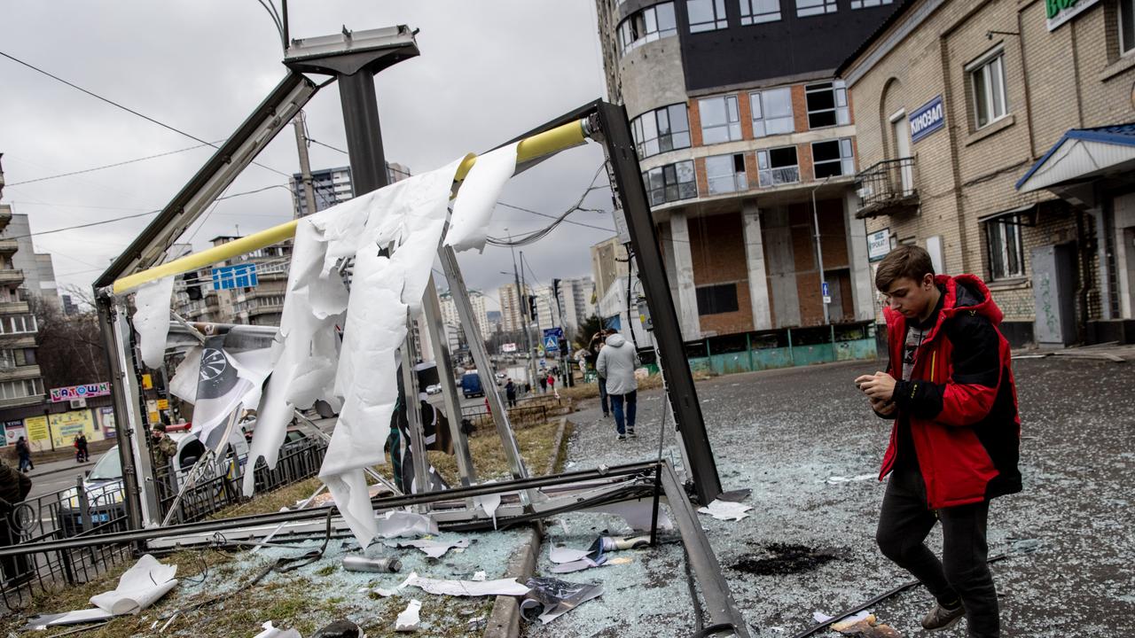 People stand around a damaged structure caused by a rocket in Kyiv, Ukraine. Picture: Chris McGrath/Getty Images